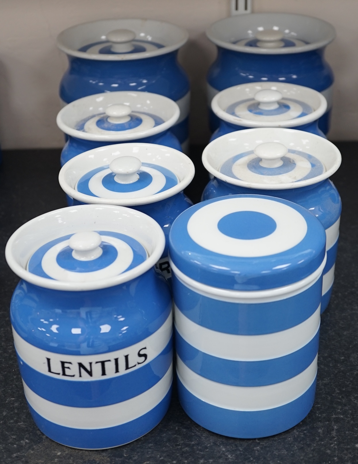 T.G.Green Cornish Kitchenware, eight lidded storage jars comprising Washing-Soda, Soda, Starch, Haricot Beans, Quaker Oats, Oatmeal, Lentils and one unnamed, largest 18cm high, mainly Black Shield marks. Condition - fair